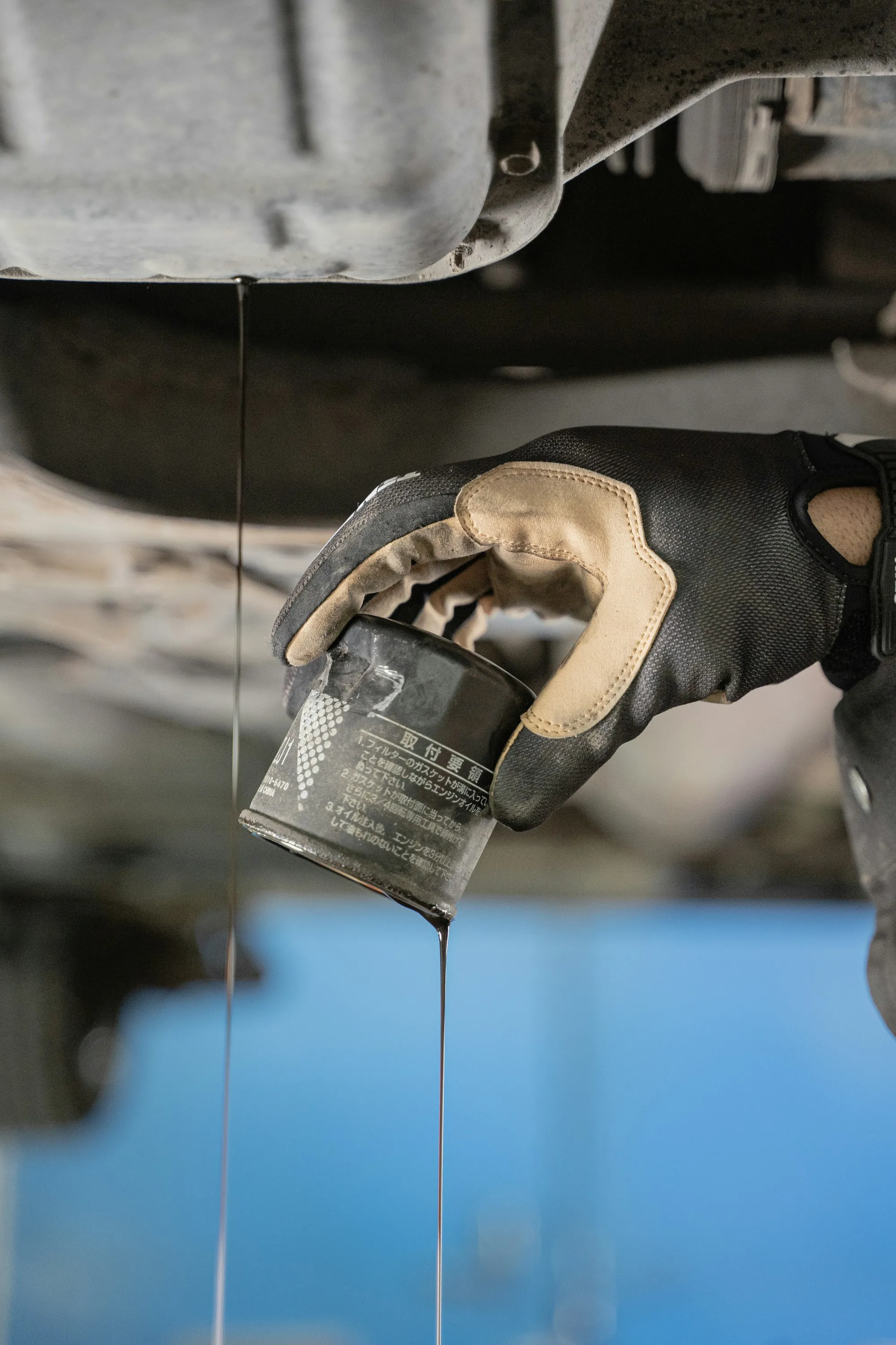 Oil draining from the bottom of an engine during an oil change