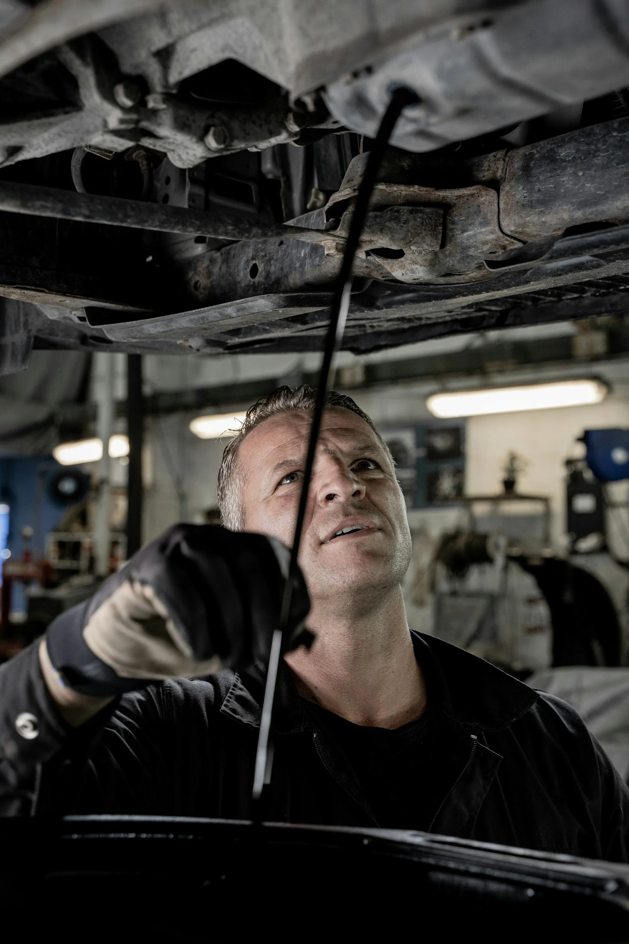Mechanic standing at a workbench in a repair shop